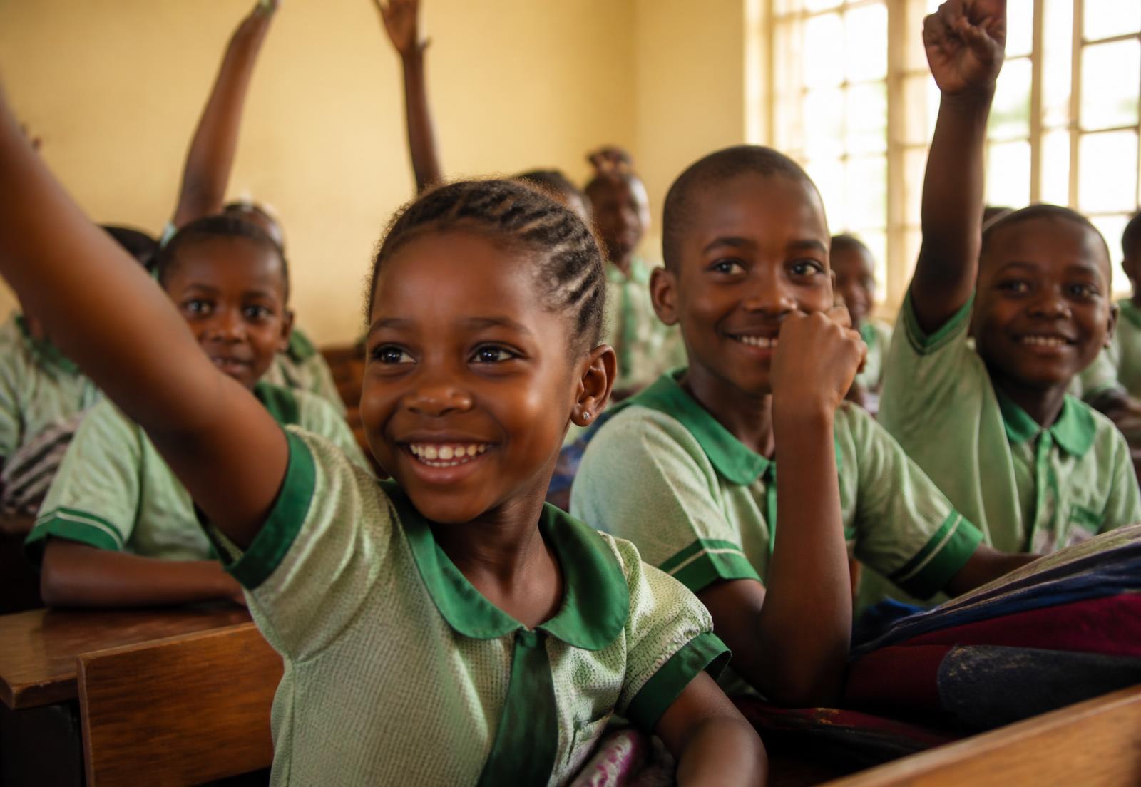Schoolchildren raising their hands in a classroom in Lagos